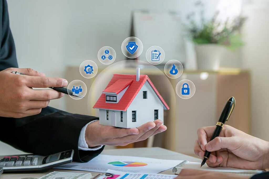 Homeowner reviewing an insurance policy beside a laptop, roof photos, receipts, and a home maintenance checklist.