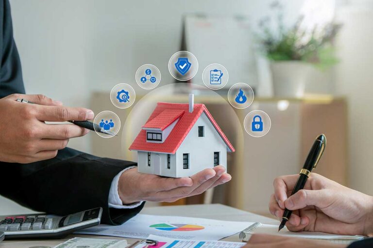 Homeowner reviewing an insurance policy beside a laptop, roof photos, receipts, and a home maintenance checklist.